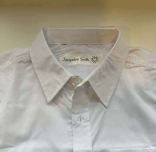 Light-colored shirt with a visible name label on a plain background